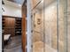 Elegant bathroom showing a glass-enclosed shower with tiled walls, complemented by a spacious walk-in closet at 7739 E Evening Glow Dr, Scottsdale, AZ 85266