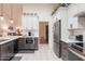 Well-lit kitchen with stainless steel appliances, white cabinetry and neutral countertops at 7942 E Nopal Ave, Mesa, AZ 85209