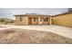 A backyard view reveals a spacious yard, a well maintained lawn, and attractive landscaping at 8210 S 132Nd Ave, Goodyear, AZ 85338