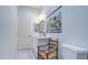 Clean bathroom with a white door, vanity, toilet, light fixture, and a hanging floral tapestry at 8210 S 132Nd Ave, Goodyear, AZ 85338