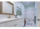 Bright bathroom featuring a white vanity with a gold-framed mirror and a shower with a curtain at 8210 S 132Nd Ave, Goodyear, AZ 85338