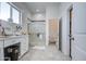 Bright bathroom with a vanity, tiled floors, and a glass-enclosed shower, offering a spa-like experience at 8210 S 132Nd Ave, Goodyear, AZ 85338