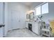 Well-lit bathroom with a vanity, tiled floors, and a separate shower area, designed for comfort and functionality at 8210 S 132Nd Ave, Goodyear, AZ 85338