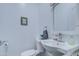 Powder room featuring a single sink, mirror, toilet, cleaning supplies and a hand towel at 8210 S 132Nd Ave, Goodyear, AZ 85338