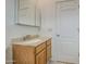 Bathroom includes a light wooden cabinet with integrated sink, a medicine cabinet, and a towel rack at 8210 S 132Nd Ave, Goodyear, AZ 85338
