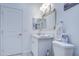 Small, tidy bathroom featuring a framed mirror and a white vanity with a sink and a toilet at 8210 S 132Nd Ave, Goodyear, AZ 85338