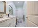 Bathroom with white cabinets, stylish tile flooring, and a walk-in shower at 8210 S 132Nd Ave, Goodyear, AZ 85338