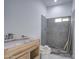 Bathroom is in the middle of remodeling and features gray tile shower and a wooden vanity at 8210 S 132Nd Ave, Goodyear, AZ 85338