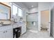 Elegant bathroom featuring a spacious vanity, tiled floors, and a glass shower, providing a luxurious feel at 8210 S 132Nd Ave, Goodyear, AZ 85338