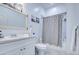 Bright bathroom featuring a shower/tub combo with a whale-patterned curtain and a white vanity at 8210 S 132Nd Ave, Goodyear, AZ 85338