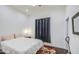 Well-lit bedroom with dark curtains, hardwood floors, and a double bed at 8210 S 132Nd Ave, Goodyear, AZ 85338
