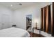 Inviting bedroom with hardwood floors, an adjacent walk-in closet, and modern lighting at 8210 S 132Nd Ave, Goodyear, AZ 85338