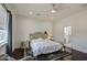 Comfortable bedroom with a tufted headboard, wood floors, and ensuite bathroom access for added convenience at 8210 S 132Nd Ave, Goodyear, AZ 85338