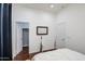 Bright bedroom featuring hardwood floors, two doors, and natural lighting at 8210 S 132Nd Ave, Goodyear, AZ 85338