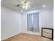 Cozy bedroom with hardwood floors, ceiling fan, and a gray accent wall at 8210 S 132Nd Ave, Goodyear, AZ 85338