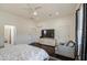 Spacious bedroom with dark hardwood floors, a ceiling fan, and an entertainment center for modern living at 8210 S 132Nd Ave, Goodyear, AZ 85338