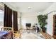 Cozy bonus room with an exercise bike, rug and ample natural light at 8210 S 132Nd Ave, Goodyear, AZ 85338