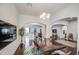 Elegant dining area featuring hardwood floors, modern lighting, archways, and stylish decor at 8210 S 132Nd Ave, Goodyear, AZ 85338