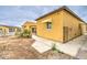 A sunny exterior reveals partial view of pool, attached awnings, and spacious gated backyard at 8210 S 132Nd Ave, Goodyear, AZ 85338