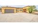 Attractive stucco home with a well-maintained driveway, garage, and comfortable front porch at 8210 S 132Nd Ave, Goodyear, AZ 85338