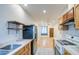 Kitchen view with stainless steel appliances and hardwood flooring in the distance at 8210 S 132Nd Ave, Goodyear, AZ 85338
