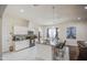 Well-lit kitchen featuring an island with bar seating and modern appliances at 8210 S 132Nd Ave, Goodyear, AZ 85338