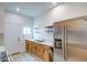 Bright kitchen showcasing stainless steel refrigerator and wooden cabinets at 8210 S 132Nd Ave, Goodyear, AZ 85338