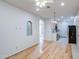 Bright living room featuring hardwood floors and archway to the kitchen at 8210 S 132Nd Ave, Goodyear, AZ 85338
