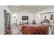Open-concept living area with hardwood floors, modern lighting, and a large comfortable sofa at 8210 S 132Nd Ave, Goodyear, AZ 85338
