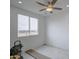 Room with tile floors, recessed lighting, ceiling fan, and a large window overlooking the landscape at 8210 S 132Nd Ave, Goodyear, AZ 85338