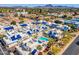 An aerial view of white stucco homes with vibrant blue roofs around a community pool and mature landscaping at 10 W Georgia Ave # 8, Phoenix, AZ 85013