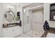 Updated bathroom featuring a glass shower, modern fixtures, and a decorative mirror at 10 W Georgia Ave # 8, Phoenix, AZ 85013