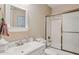 Bathroom featuring a vanity with sink and a bathtub with glass doors at 10 W Georgia Ave # 8, Phoenix, AZ 85013