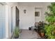 Inviting porch area with comfortable seating, potted plants, and a secured front door at 10 W Georgia Ave # 8, Phoenix, AZ 85013
