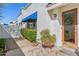Charming front entrance with desert landscaping, covered patio, and a textured white exterior at 10 W Georgia Ave # 8, Phoenix, AZ 85013