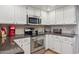 Bright kitchen featuring stainless steel appliances, white cabinetry and a stylish tile backsplash at 10 W Georgia Ave # 8, Phoenix, AZ 85013