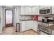 Traditional-style kitchen with white cabinets, stainless steel appliances, and tile flooring at 10 W Georgia Ave # 8, Phoenix, AZ 85013