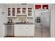 A kitchen with stainless steel appliances, white cabinets, and red interior accents at 10 W Georgia Ave # 8, Phoenix, AZ 85013