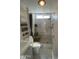 Bright bathroom featuring a modern vanity, built-in shelving, toilet, and a tiled walk-in shower with a window at 1118 S Shawnee Dr, Apache Junction, AZ 85119