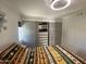 Comfortable bedroom featuring a closet, window, and laminate flooring at 1118 S Shawnee Dr, Apache Junction, AZ 85119