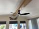 Modern ceiling fan adds a sleek touch to this bright living space, vaulted ceiling and a decorative wall element at 1118 S Shawnee Dr, Apache Junction, AZ 85119