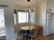 Cozy dining nook with a bay window, modern light fixture, and convenient access to the kitchen at 1118 S Shawnee Dr, Apache Junction, AZ 85119