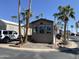 Well-maintained exterior with mature palm trees and convenient street access at 1118 S Shawnee Dr, Apache Junction, AZ 85119