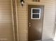 A welcoming brown front door with a window pane, perfect for entry at 1118 S Shawnee Dr, Apache Junction, AZ 85119