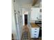 Efficient kitchen features white cabinets, modern appliances, and a black and white checkered rug at 1118 S Shawnee Dr, Apache Junction, AZ 85119