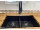 Close up on a kitchen sink with a wood countertop and black faucet at 1118 S Shawnee Dr, Apache Junction, AZ 85119