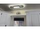 Bright kitchen with white cabinets, decor shelf, and a window with closed blinds at 1118 S Shawnee Dr, Apache Junction, AZ 85119