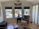 Bright living room with wood floors, multiple windows, and cozy seating arrangement at 1118 S Shawnee Dr, Apache Junction, AZ 85119
