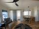 Cozy living room features wood flooring, ample natural light, and a ceiling fan at 1118 S Shawnee Dr, Apache Junction, AZ 85119