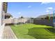 Green backyard featuring artificial turf, and a secure fenced area, perfect for pet lovers at 11607 W Marguerite Ave, Avondale, AZ 85323
